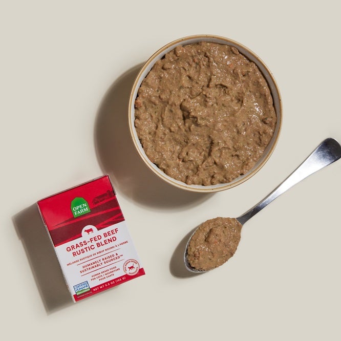Grass-Feed rustic stew with red label next to bowl of stew and spoon
