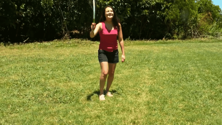 An animated GIF of a woman playing fetch with her dog using a Chuckit! launcher in a grassy field and at the beach.