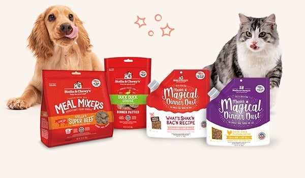 Stella & Chewy's products featuring Meal Mixers, Dinner Patties, and Magical Dinner Dust, with a happy Golden Retriever and a gray and white cat sitting next to the products.